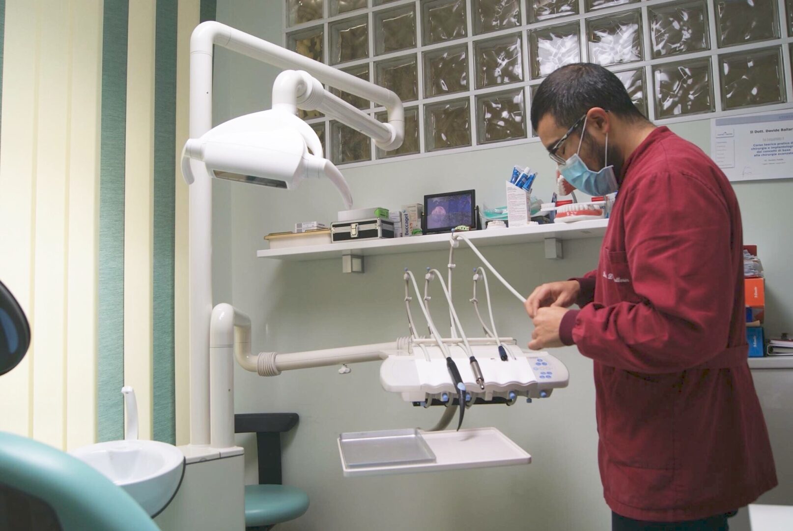 A man is working in an office with dental equipment.